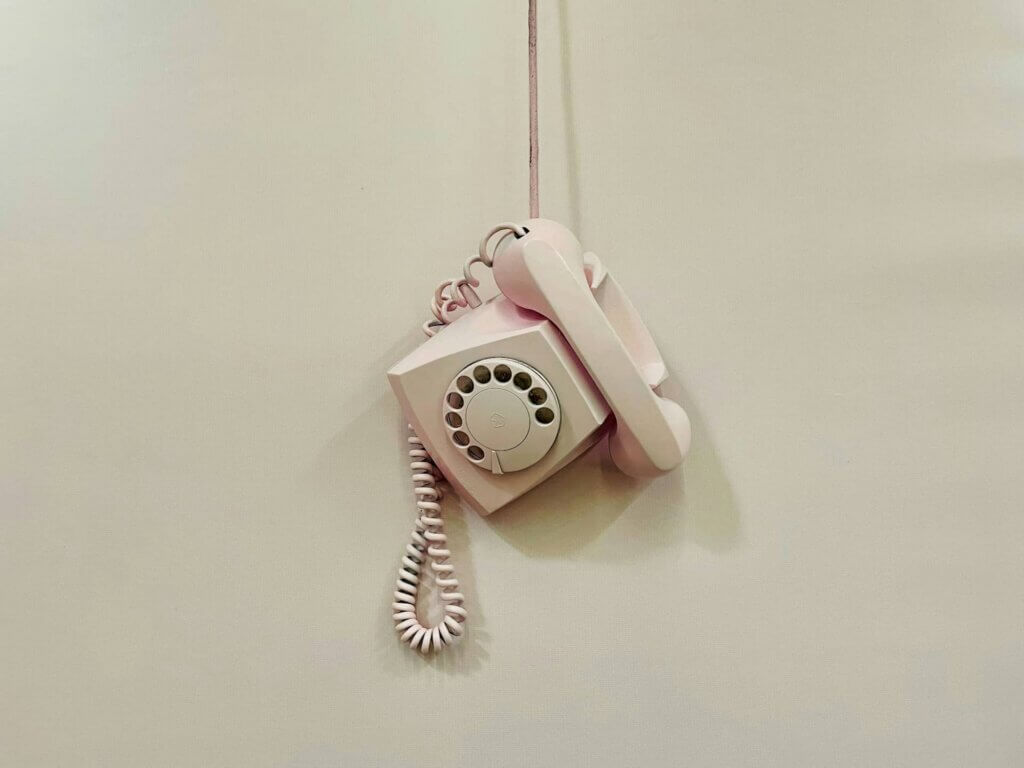 A telephone hanging on a wall