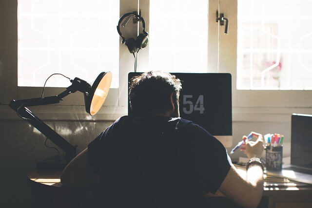 A young man working in front of the computer