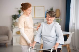 A caregiver assisting an elderly